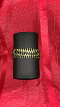 Wide multi-strand beaded stretch cuff bracelet. It